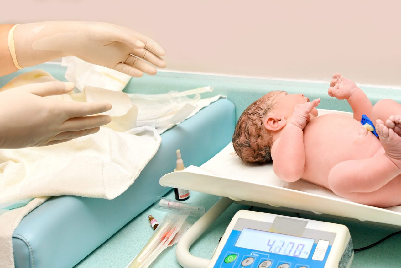 a-nurse-weighs-on-the-scales-of-a-newborn-baby-2022-09-23-23-16-40-utc-scaled-1280x854.jpg